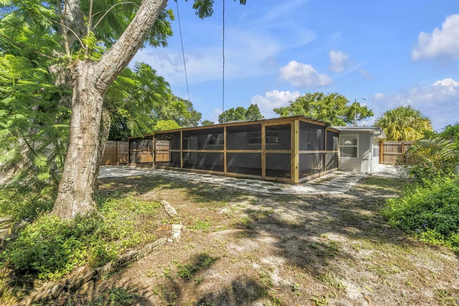 Fenced backyard with mature landscape