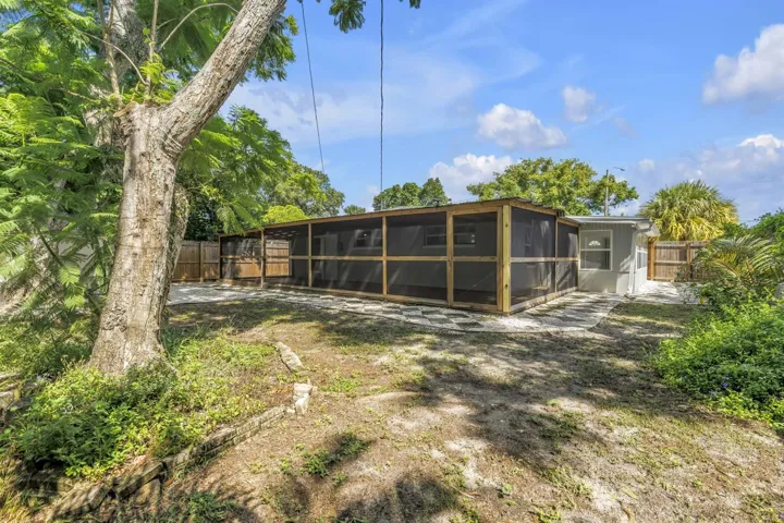 Fenced backyard with mature landscape