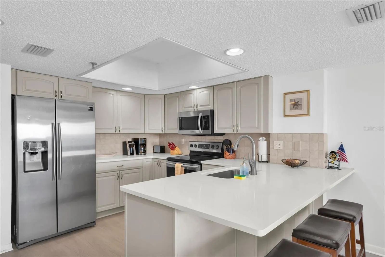 Bright clean kitchen with lots of cabinet and counter space