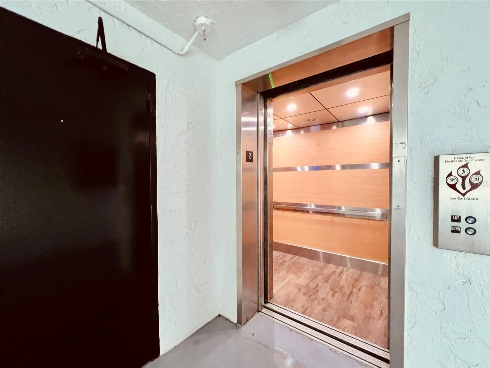 Modern elevator right by the laundry room.