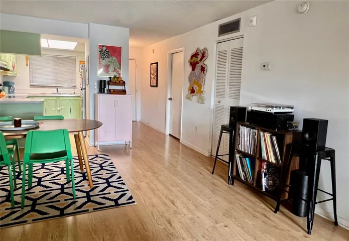 Hard wood floors and room for large table for dining.