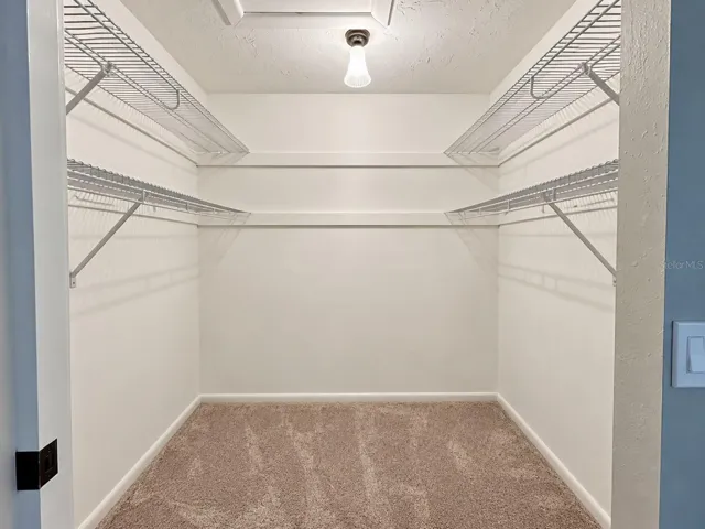 Primary bedroom walk in closet.