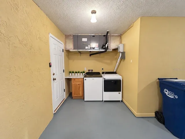 Laundry room with washer and dryer only 2yrs old , folding area perfect and convenient.