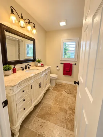 Updated Full Bathroom with luxury vanity /marble counter tops, detailed tiled shower