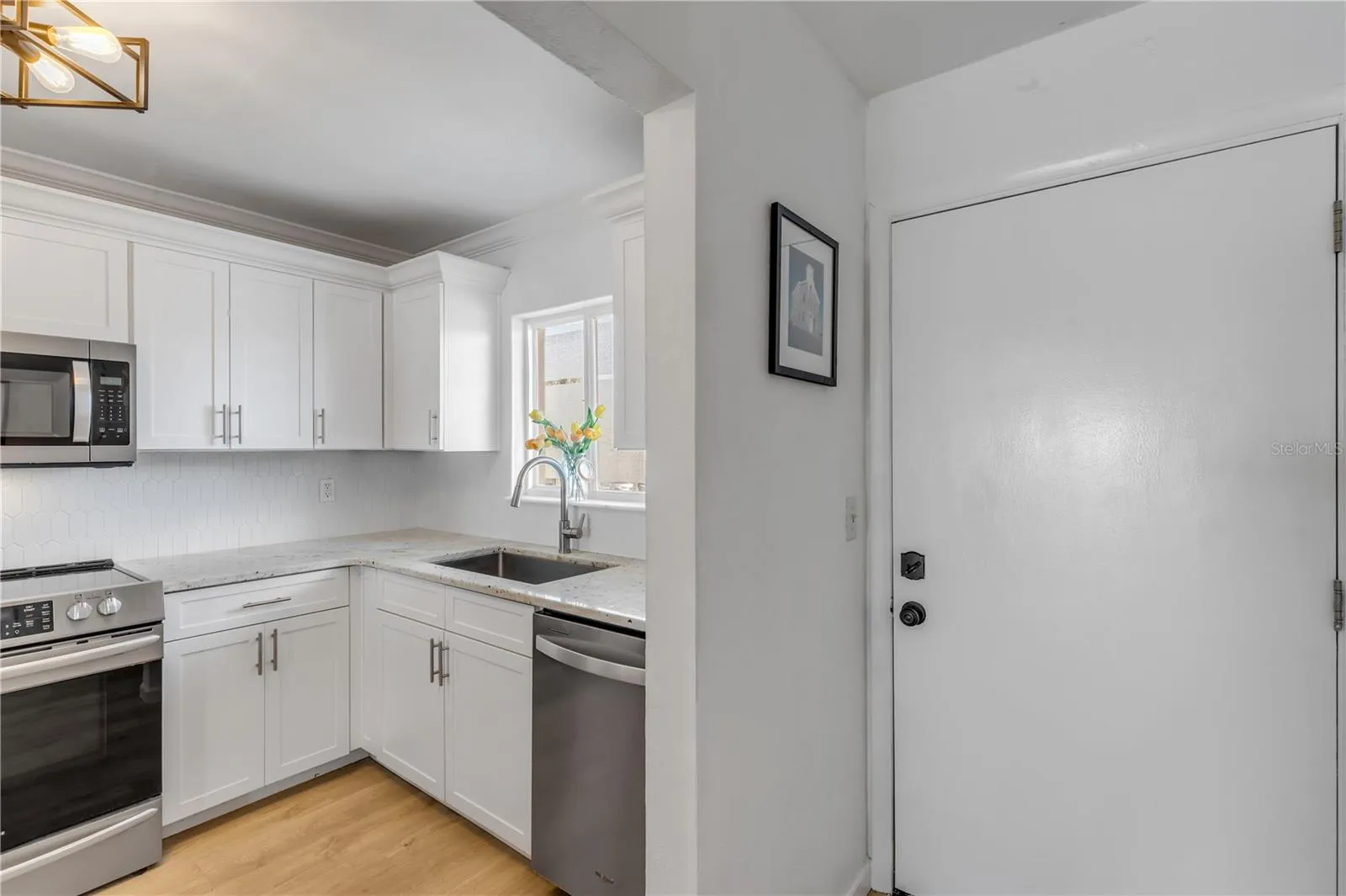 Renovated Kitchen from hardware to lighting and sparkling new cabinets.