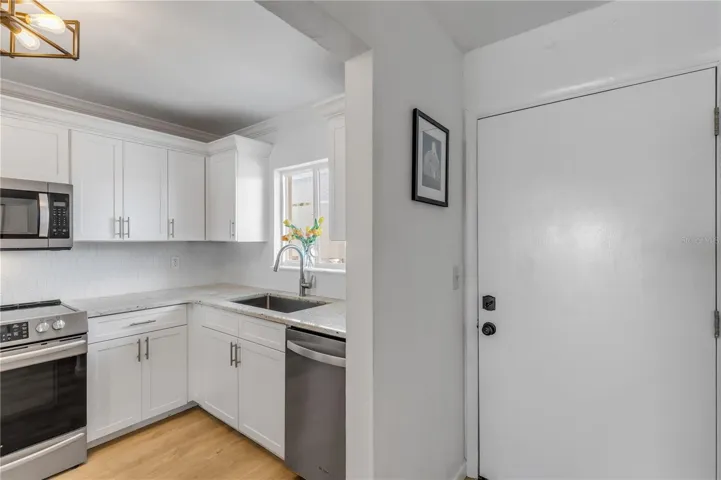 Renovated Kitchen from hardware to lighting and sparkling new cabinets.