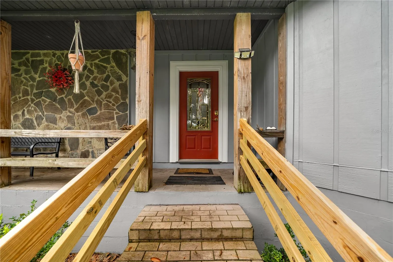 Front entrance with covered porch and walkway leading to the front door.