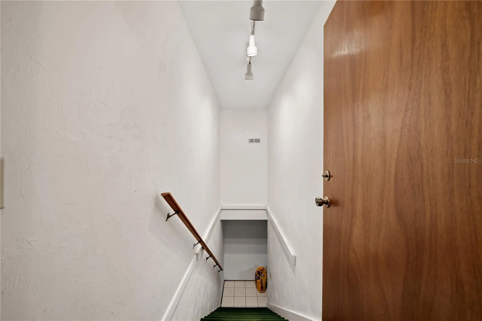 SBedroom 4 with hidden closet.tairs leading to the bottom/basement bonus room.