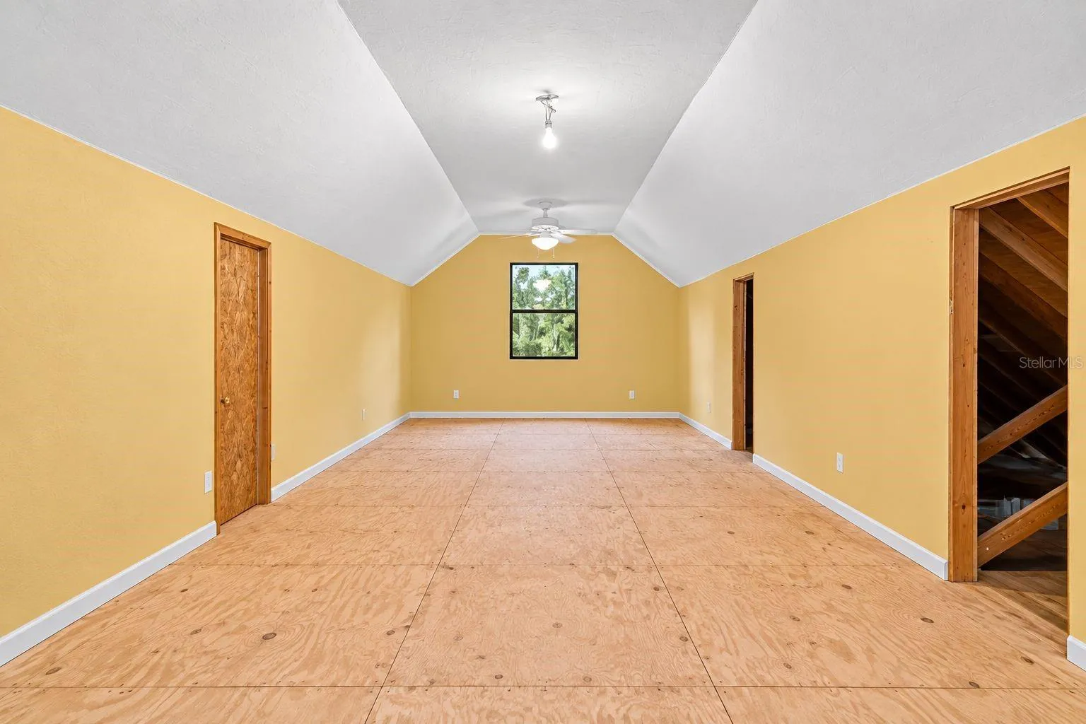 Bonus Room Above the Garage. This photo has been digitally cleaned up to remove personal items and clutter for a clearer view of the room and its layout.