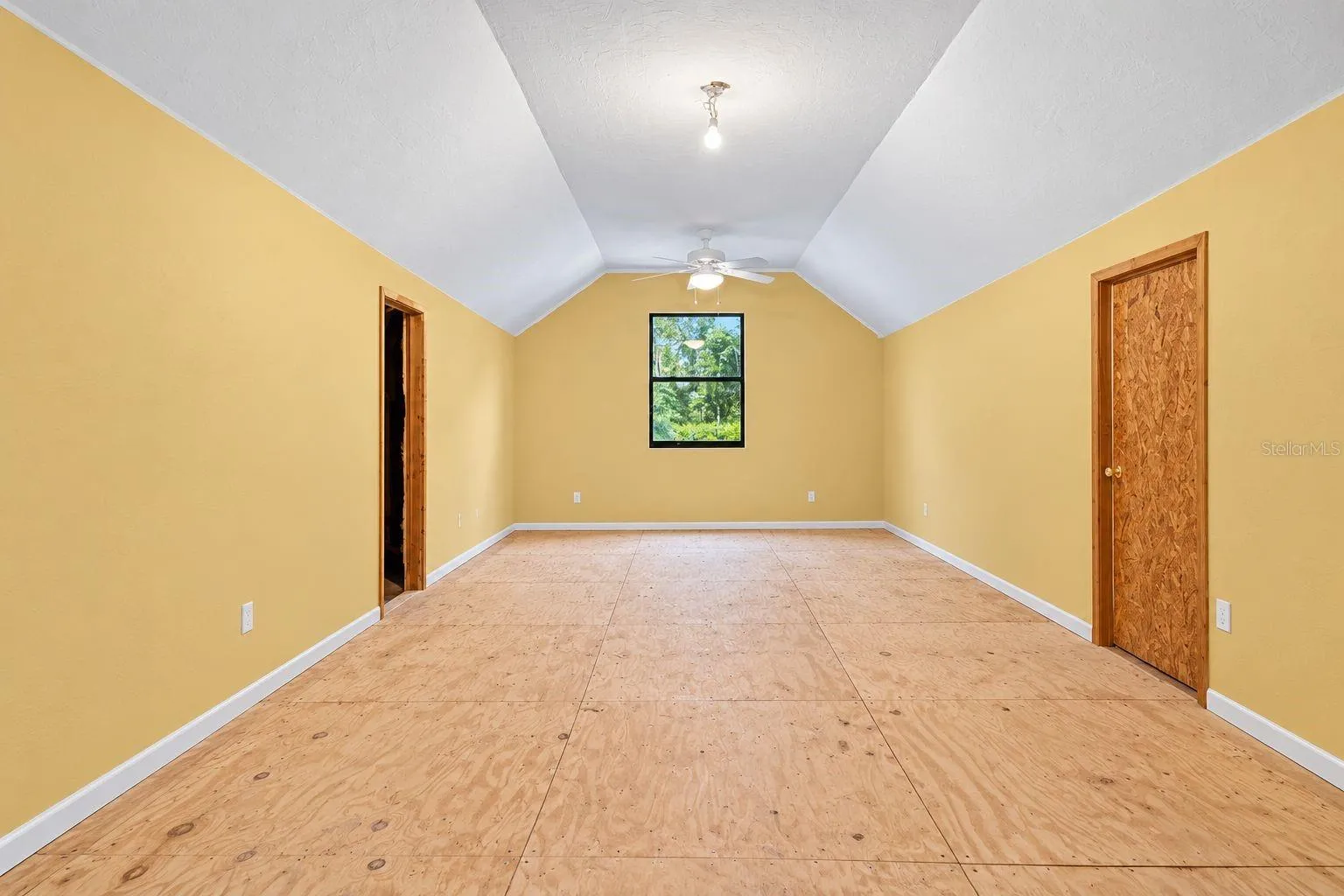 Bonus Room Above the Garage. This photo has been digitally cleaned up to remove personal items and clutter for a clearer view of the room and its layout.
