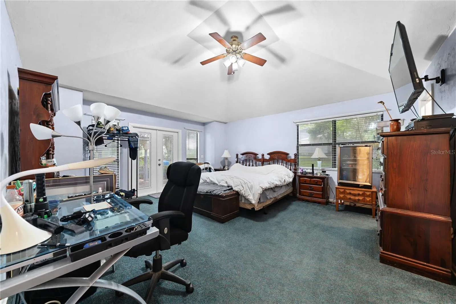 Primary Bedroom with French doors leading to back patio.