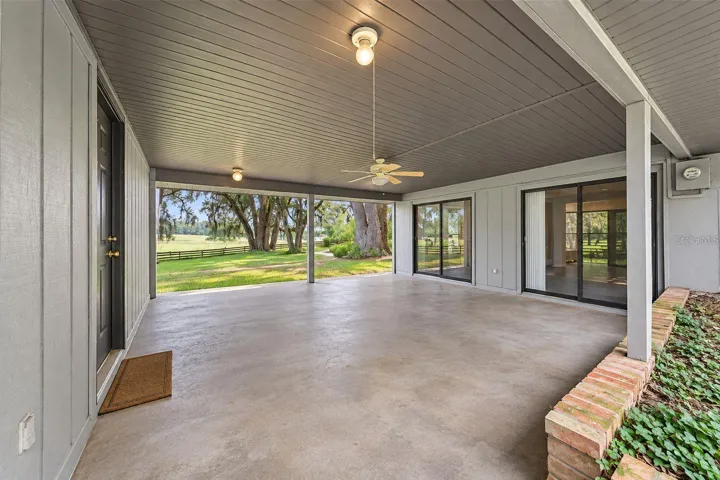 Covered breezeway connecting the home and garage. This photo has been digitally cleaned up to remove personal items and clutter for a clearer view of the room and its layout.