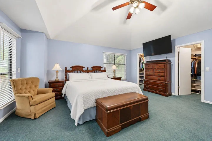 Primary bedroom with two walk-in closets. This photo has been digitally cleaned up to remove personal items and clutter for a clearer view of the room and its layout.