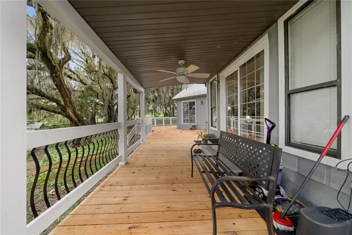 Spacious covered back patio overlooking the beautifully wooded backyard.
