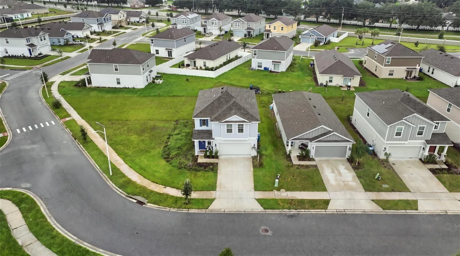 Aerial view of the property and the community