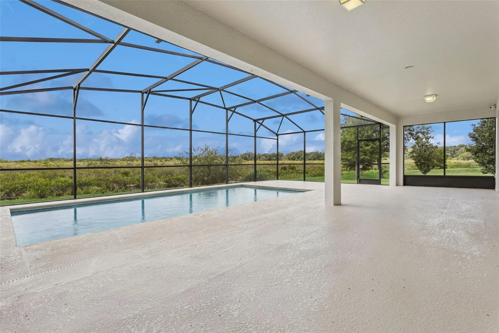 Large screen enclosed lanai with inground pool, overlooking the canal and conservation area