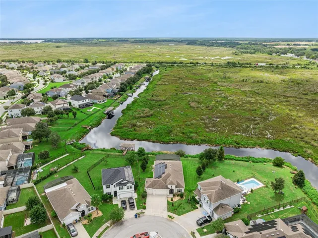 Aerial View showing the canal leading to the Clermont chain of Lakes and the conservation area behind the home.