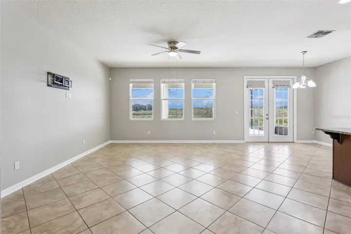 Living Room with French doors leading to the enclosed pool deck!
