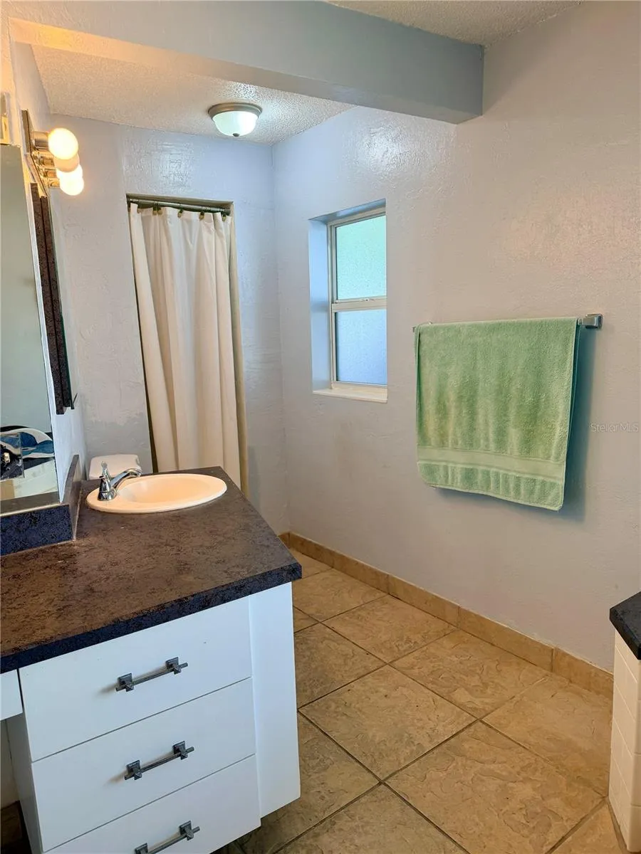 primary bathroom with tub and separate shower