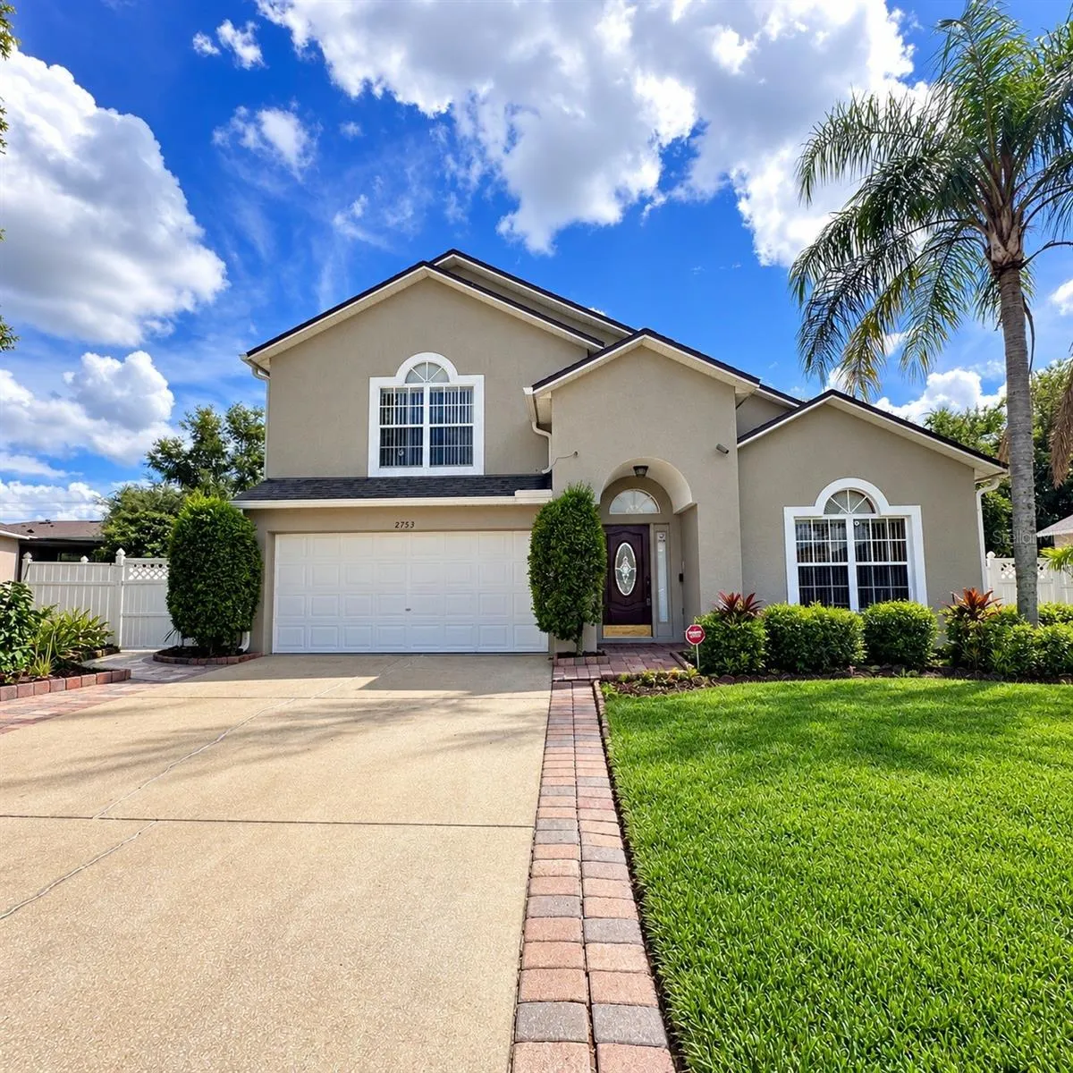 Front exterior view of home with driveway and garage