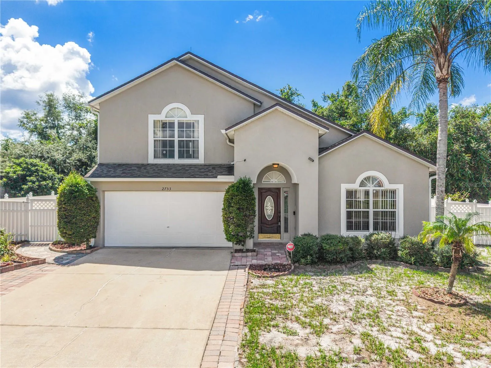 Front exterior view of home with driveway and garage