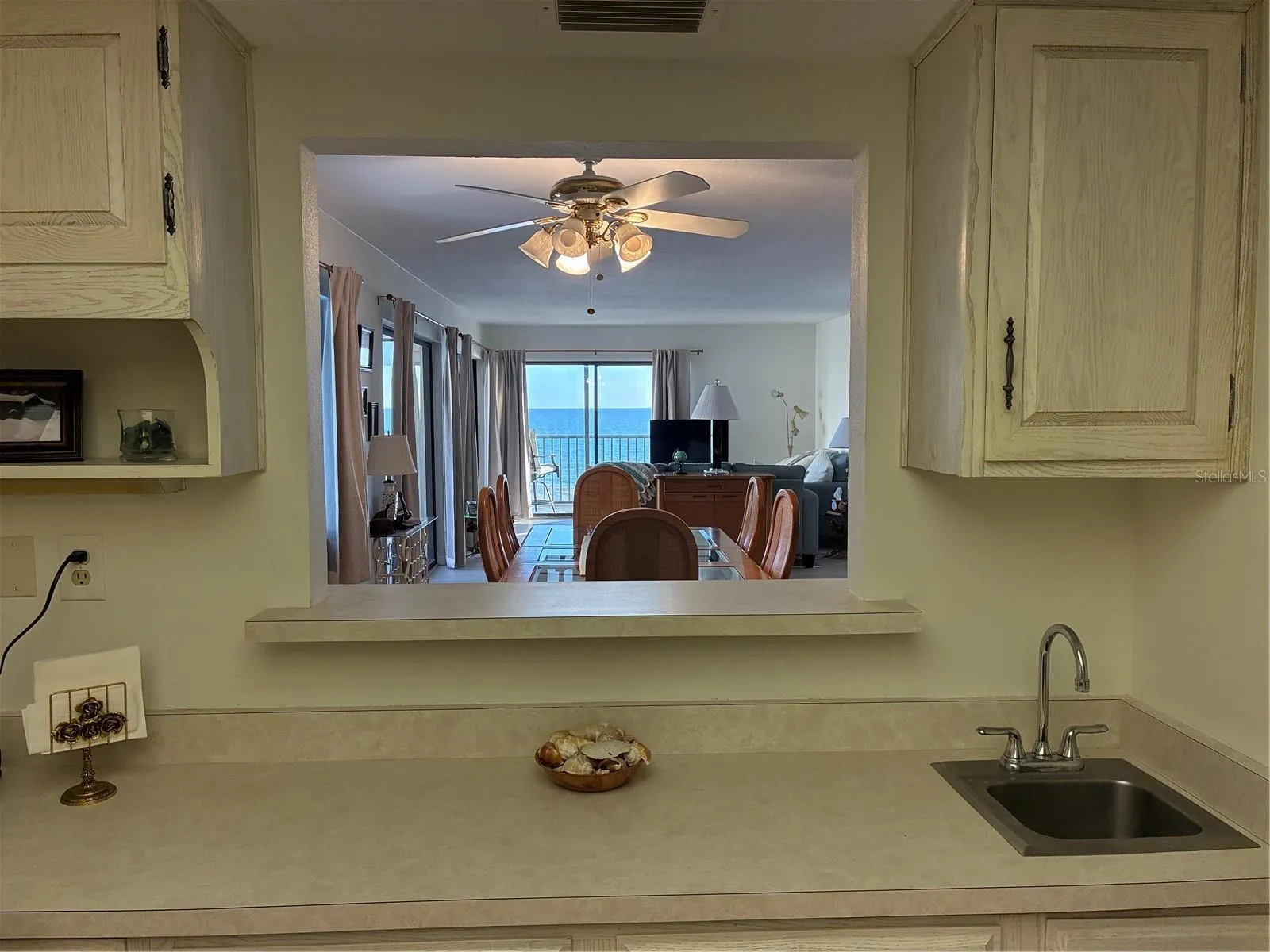 Kitchen view to dining room/living room and view