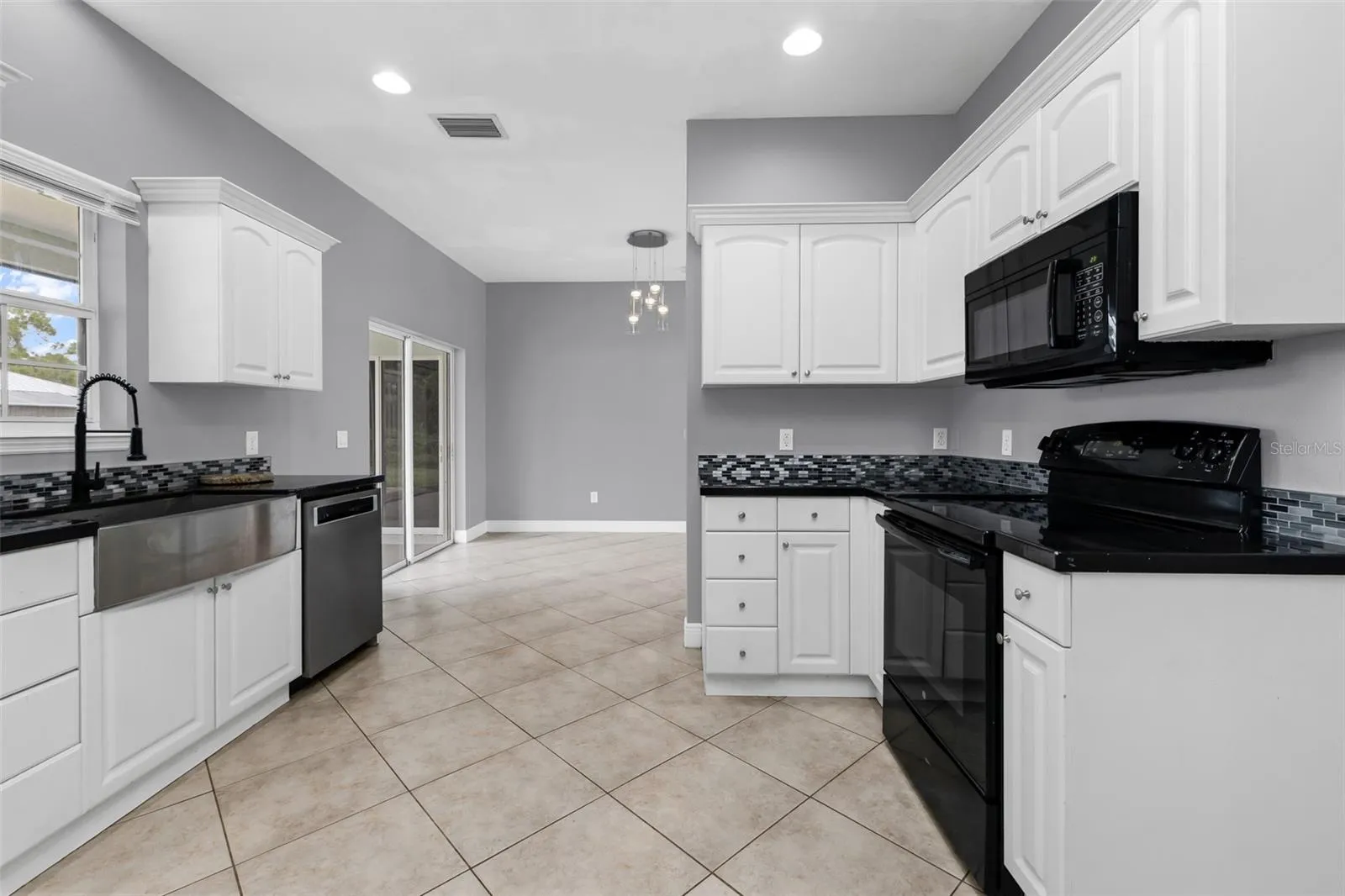 Kitchen features stainless steel farmers sink.