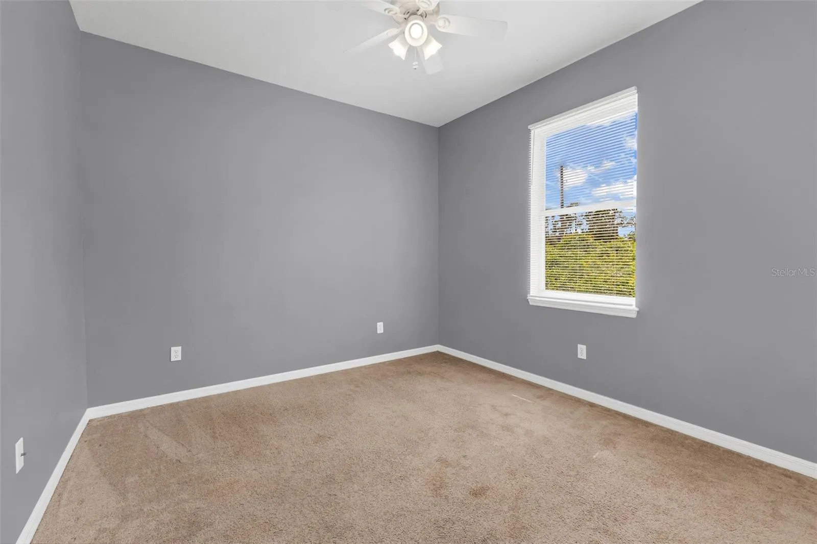 Guest bedroom 2 with carpet flooring.