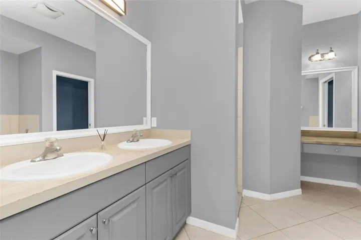 Primary bathroom features dual sinks, walk-in-shower, and garden tub.