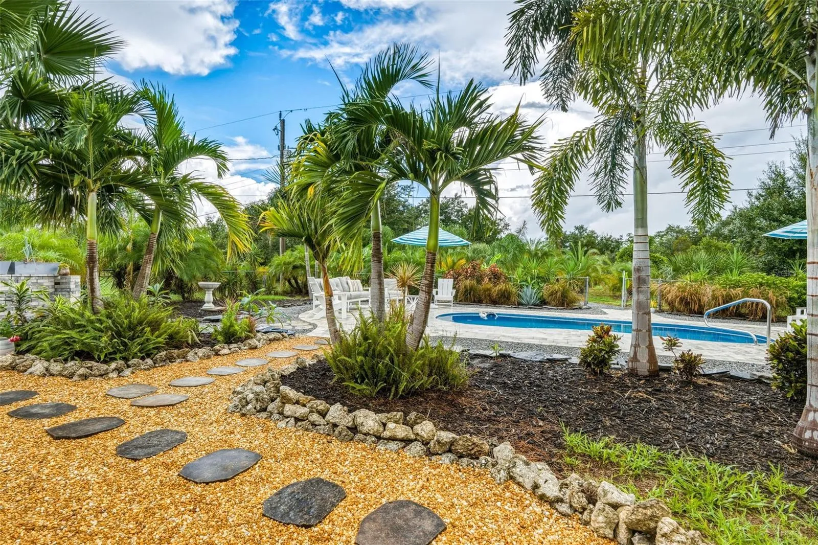 Tropical Oasis Found with Mature Florida Palms & Walkways