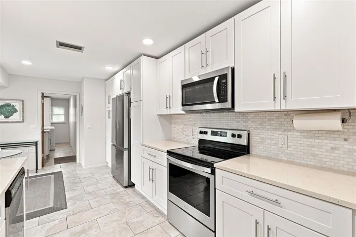 Stainless Appliances, Tile Backsplash, Custom Accents