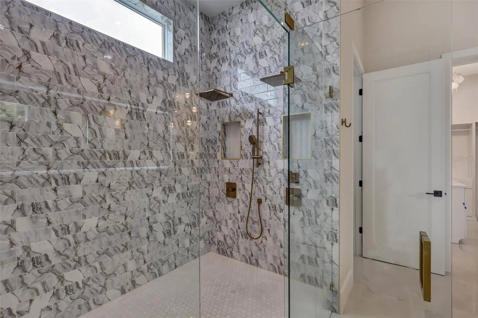 Dual-shower wet room finished in striking floor-to-ceiling stone