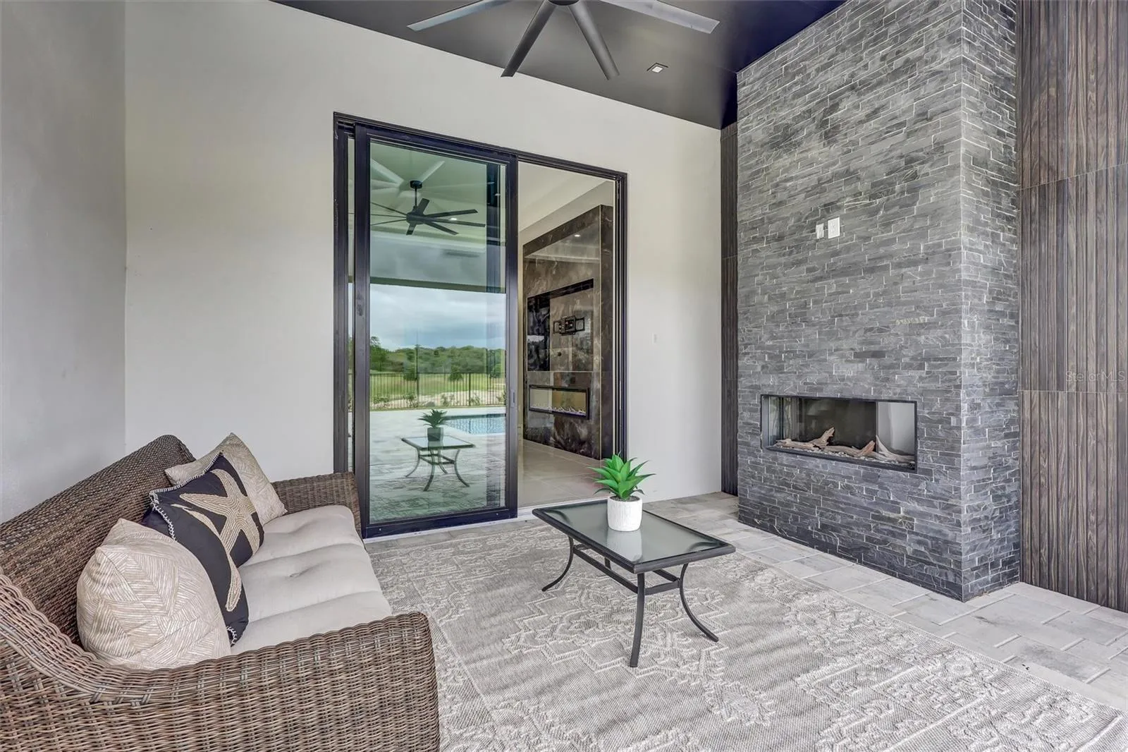 Primary retreat with fireplace and views toward the pool. Just add TV.