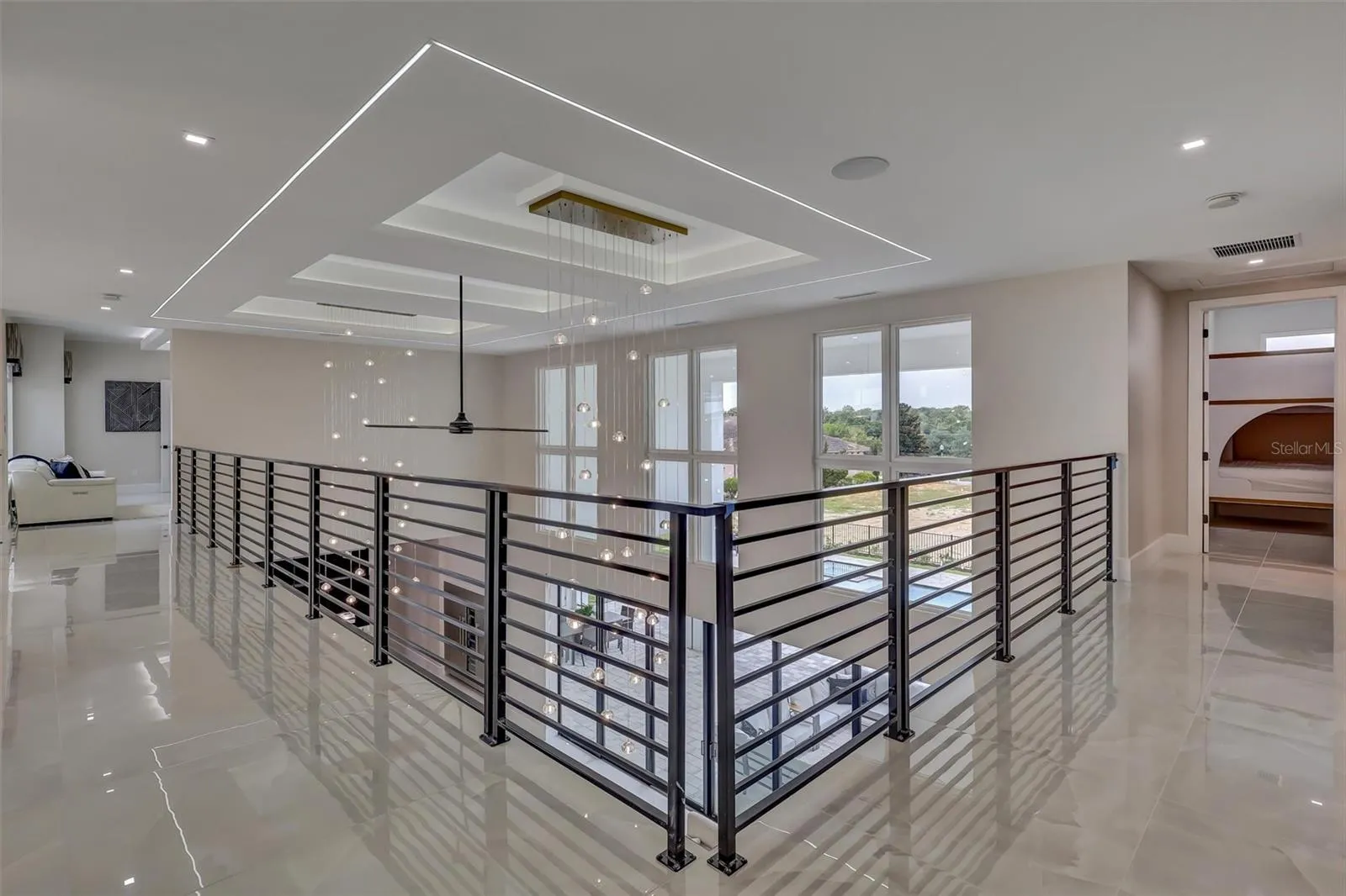 Open upper gallery connects the second-floor living spaces