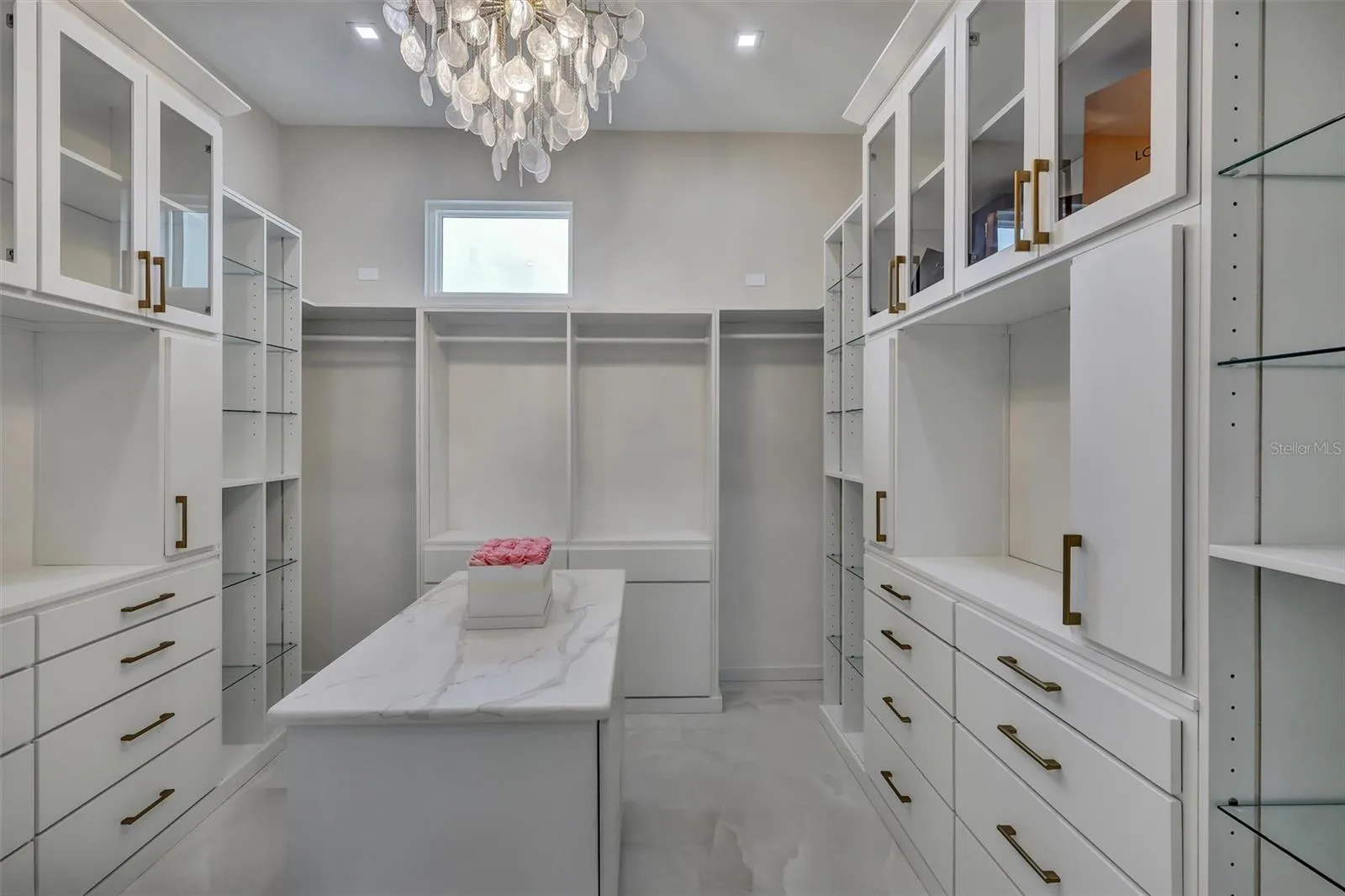 Custom primary dressing room with extensive built-in cabinetry and center island