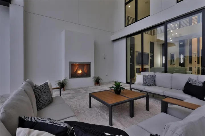 Private covered outdoor retreat with fireplace and direct access to the great room with pocketing sliders that hide behind the wall
