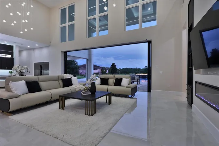 Two-story windows and expansive glass connect the interior with the outdoors