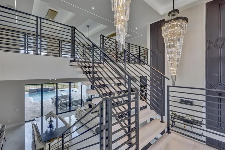 Architectural floating staircase creates a dramatic focal point between both levels
