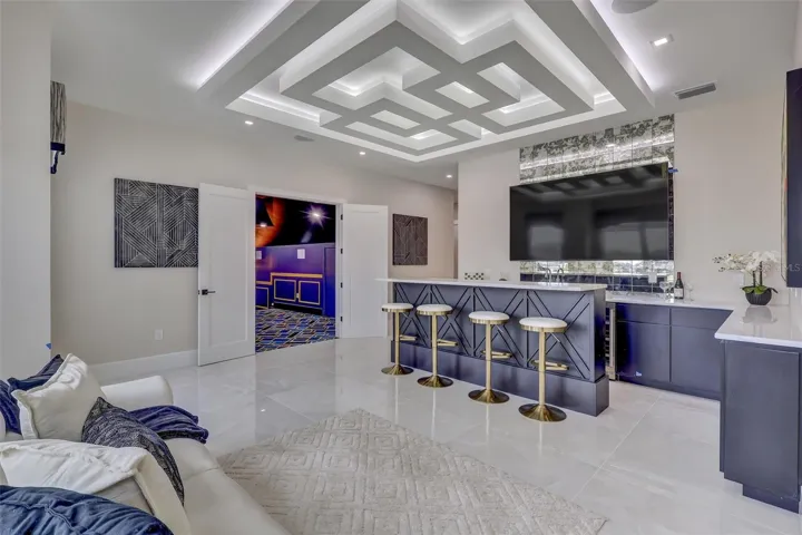 Upstairs lounge with custom wet bar and distinctive ceiling detail