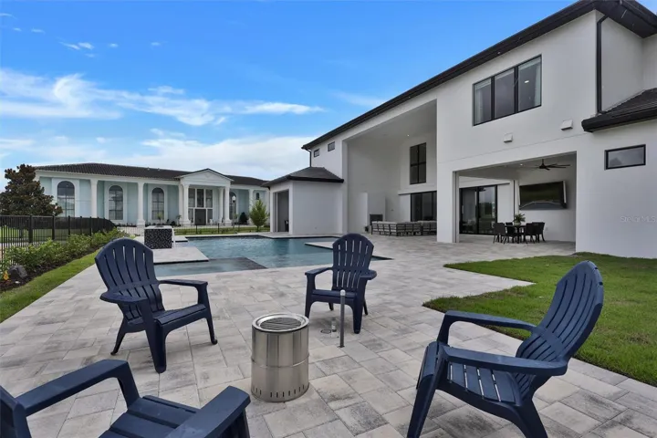 Huge pool deck with a firepit for intimate shared moments