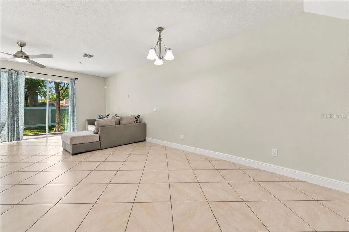 Open-concept living area with tile flooring and abundant natural light