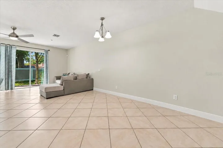 Open-concept living area with tile flooring and abundant natural light