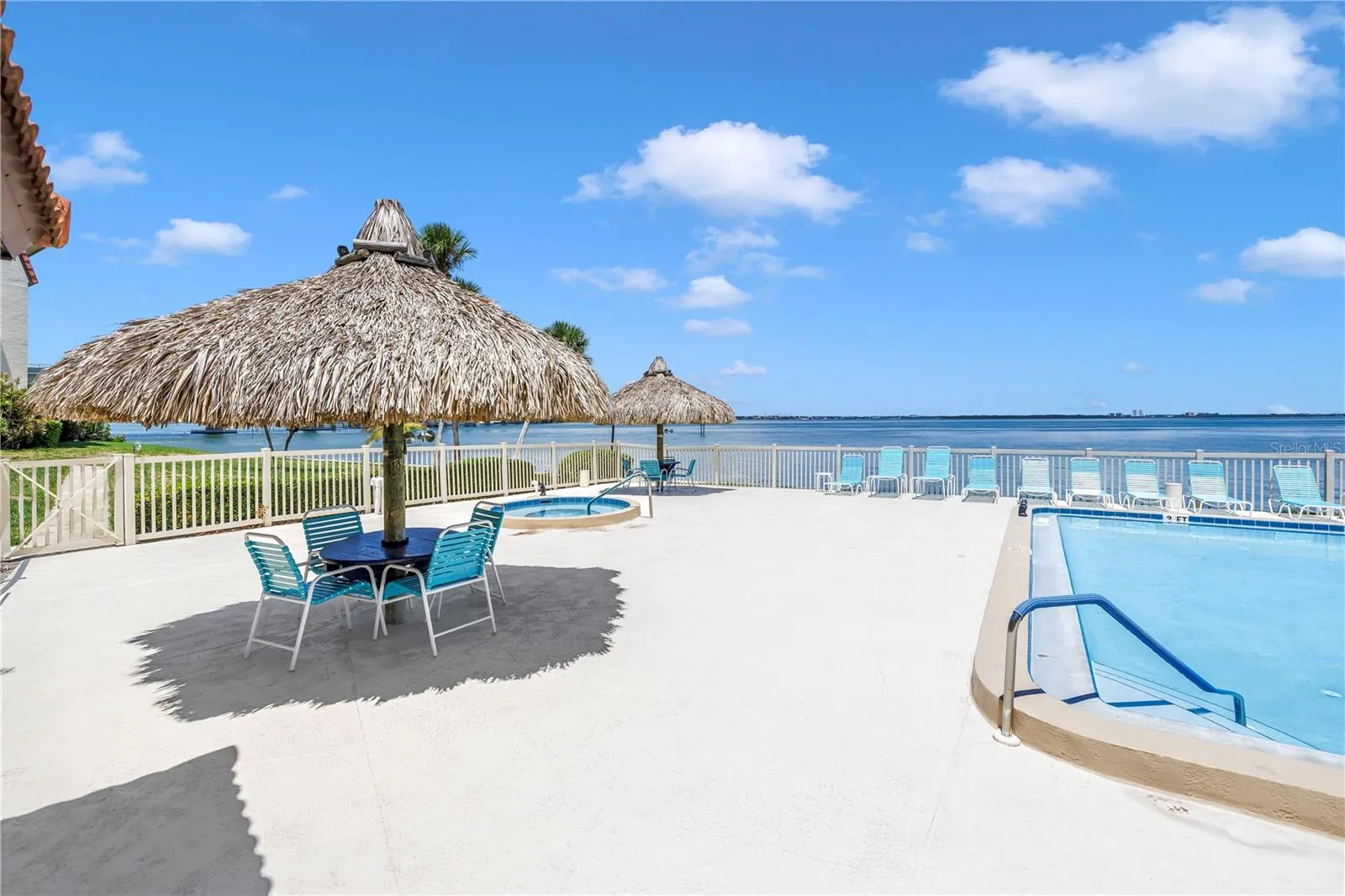 Pool on the water with tiki huts