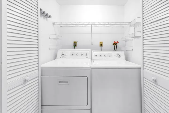 Inside Laundry Closet with full size Washer and Dryer