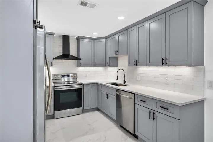 Kitchen has brand new cabinets, stainless steel appliances, and quartz countertops.