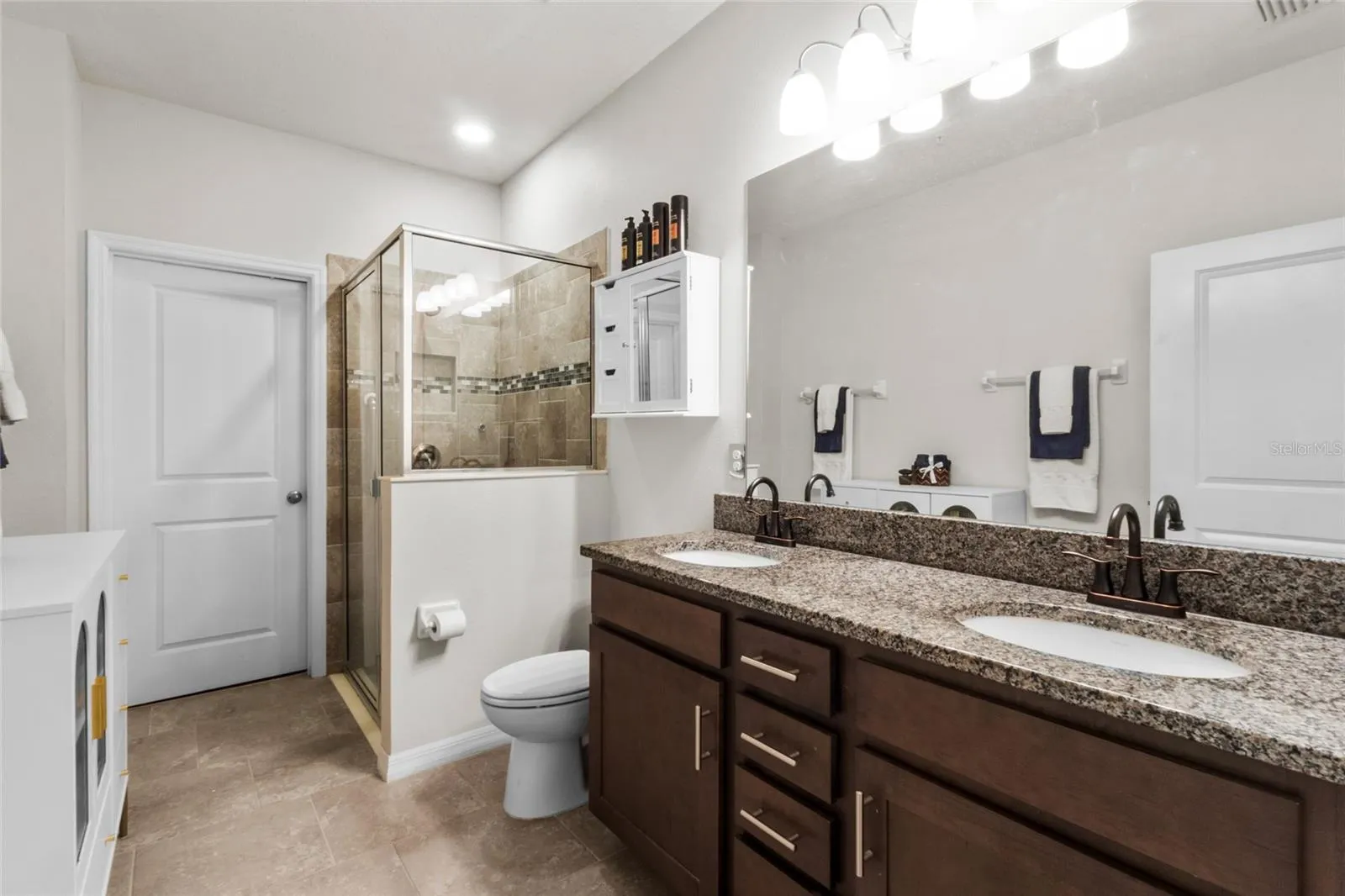 Primary Bath with Walk in Shower, Dual Vanities, and Walk in Closet
