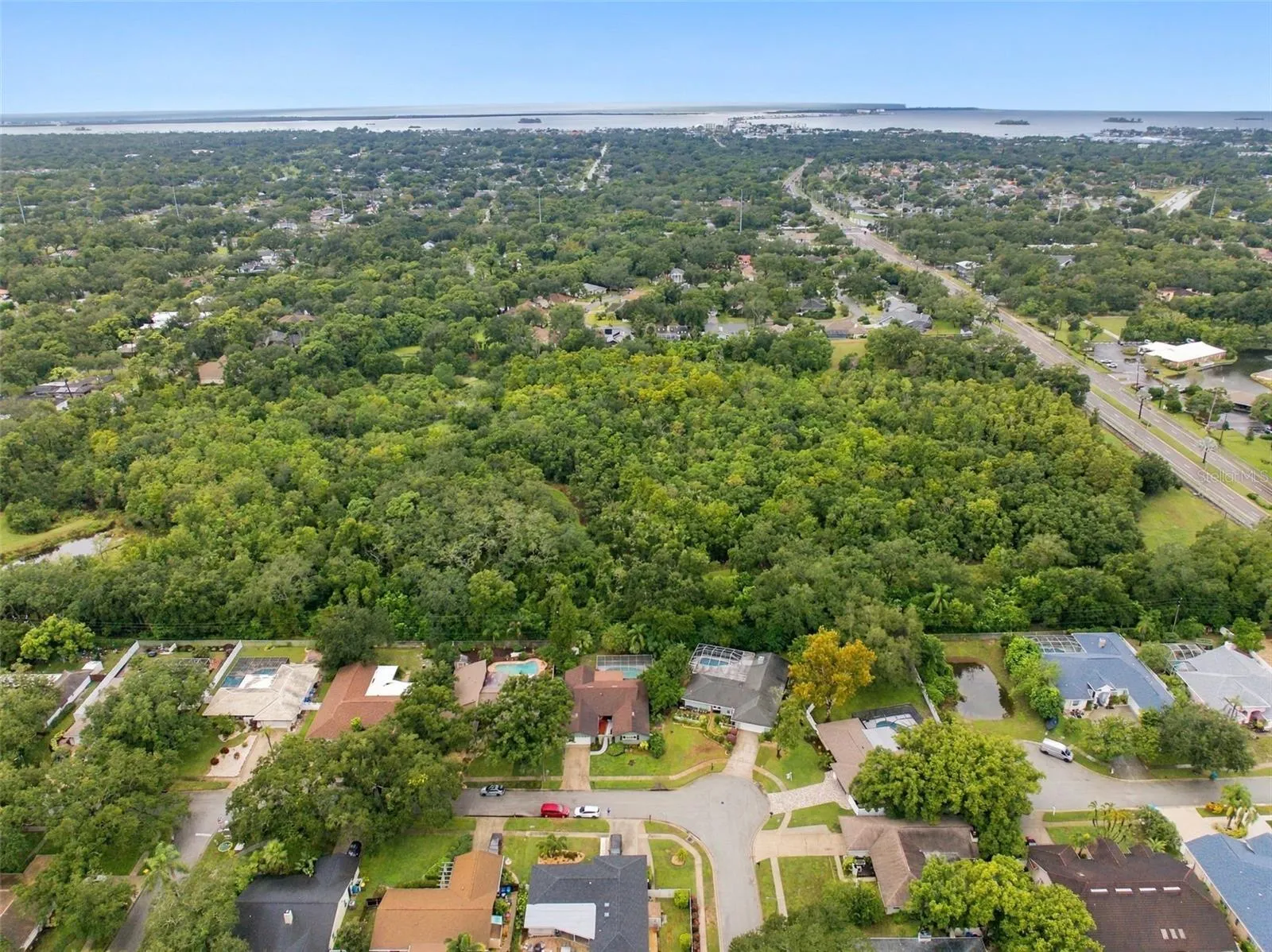 Nestled among the tree-lined streets of Spanish Pines, this residence backs onto Curlew Pond Nature Preserve.