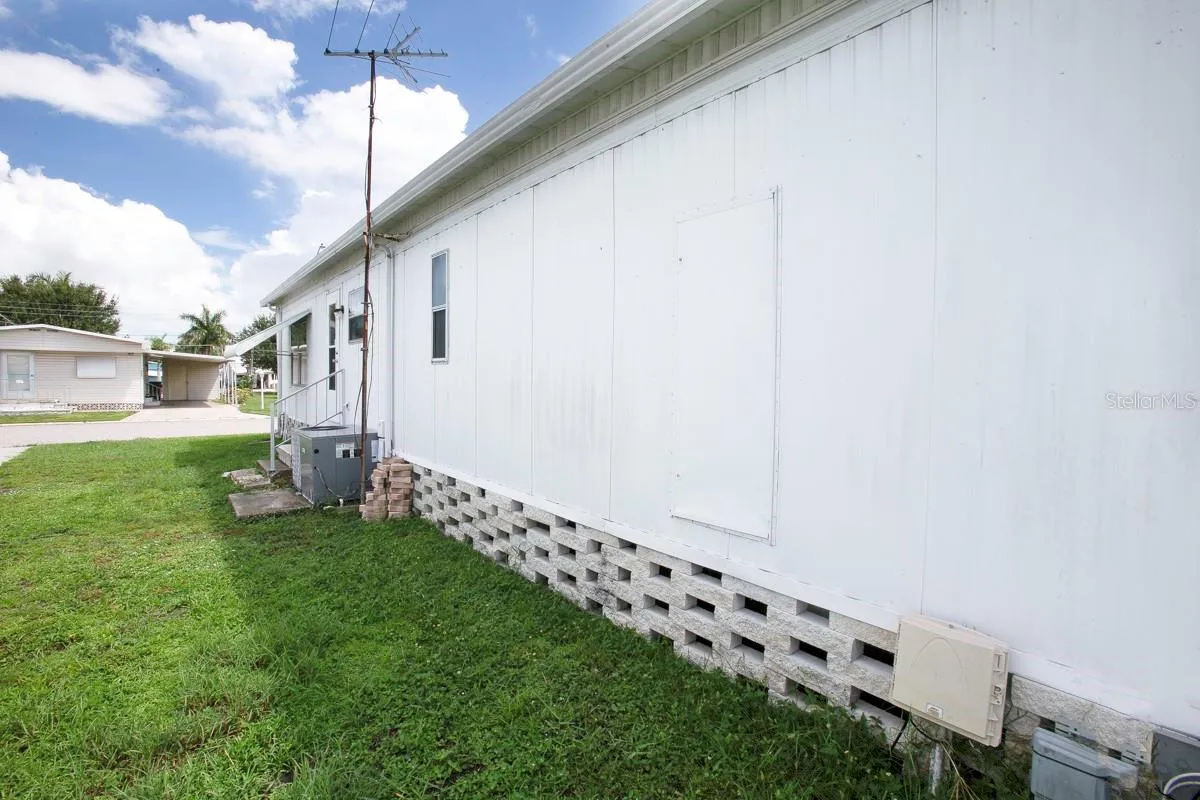 Side of home with door to water heater