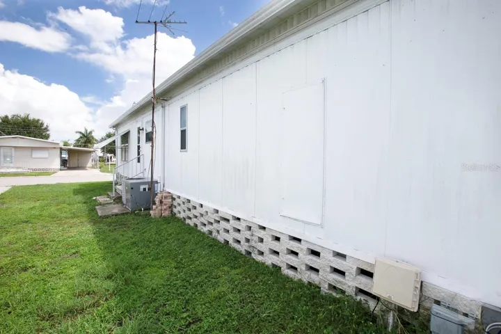 Side of home with door to water heater