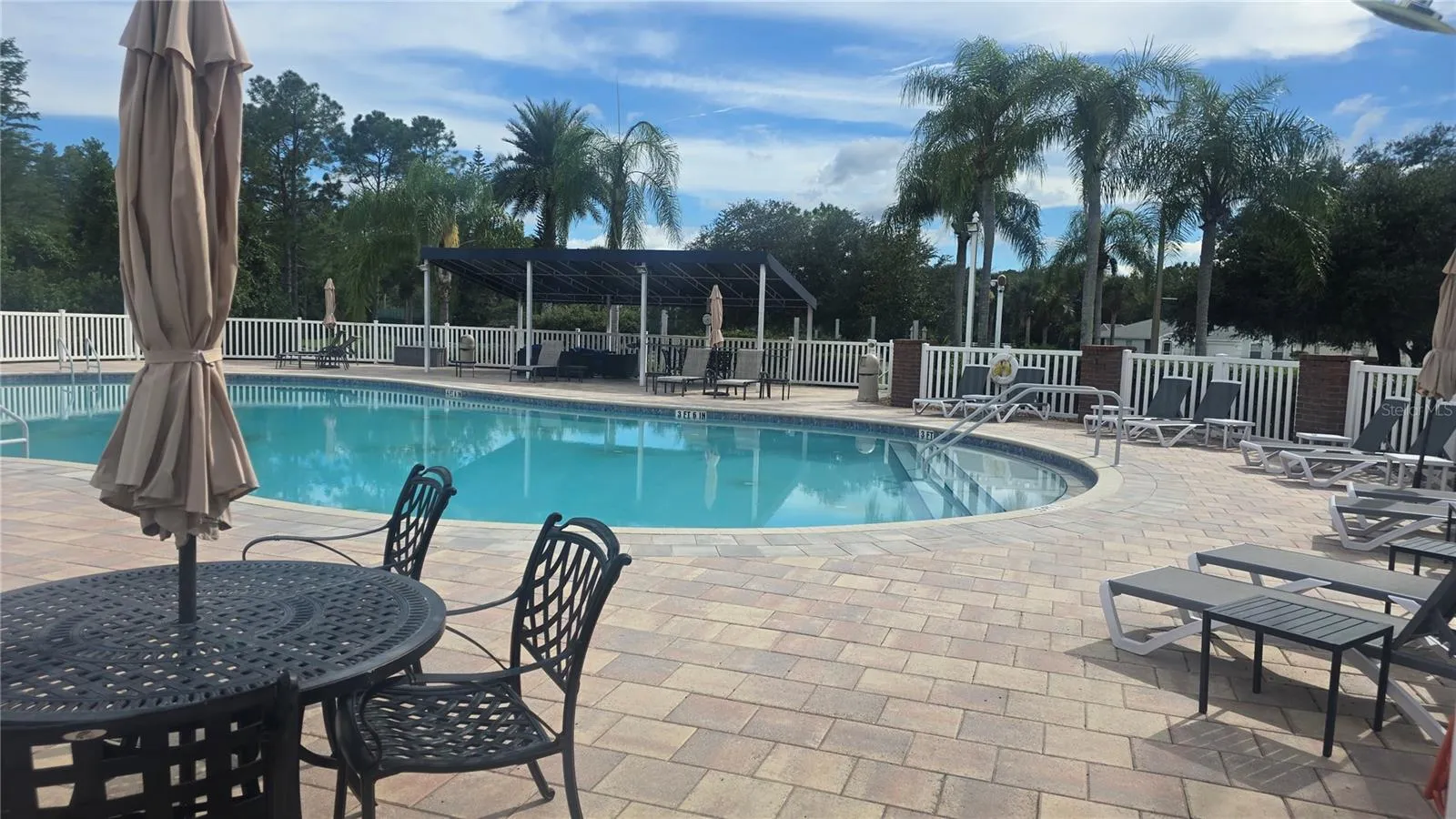 Dining or sunbathing by the pool, hot tub and community grill